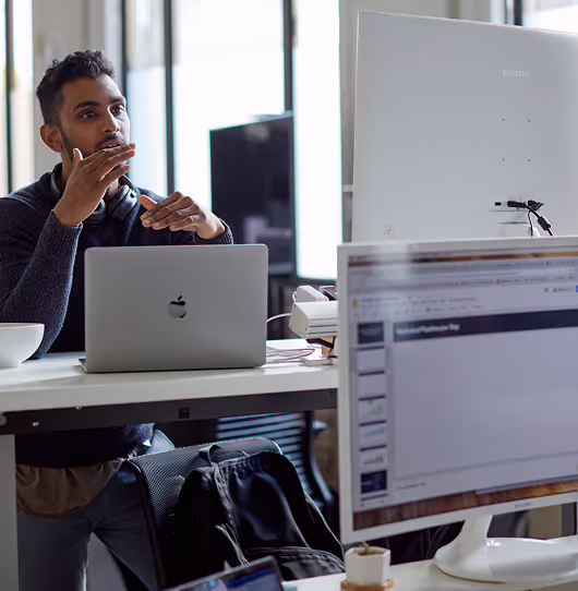A developer at a standing desk discussing Roadmap priorities